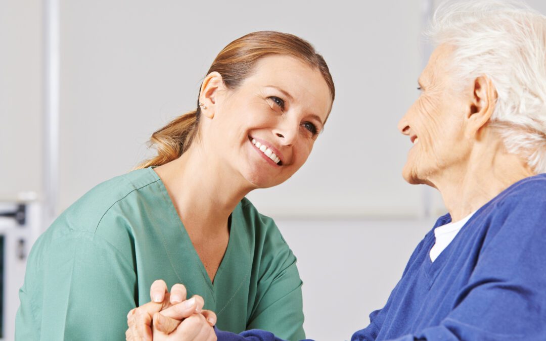 Caregiver and patient in wheelchair smiling